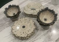 Overall view of all plates and bowls arranged on countertop