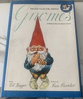 Front cover of the Gnomes Deluxe Collector's Edition book featuring an illustrated gnome in red hat and blue coat.