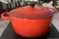 Front angle of cherry red dutch oven with lid on