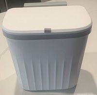 Front view of white 2-way hanging trash can with gray rim lid, rectangular shape, and smooth front surface.