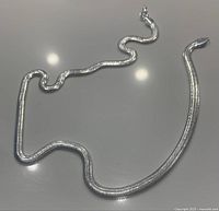 Silver flat snake chain necklace of approximately 20 inches laid out with lobster clasp showing.