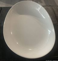 Top view of the glossy white kidney-shaped serving bowl showing the smooth surface and shape