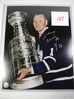 Full image of the autographed photo showing Johnny Bower with the Stanley Cup and visible signature.