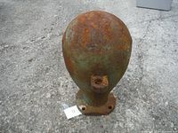 Front view of the large rusted cast iron object showing rounded top and square hollow extension at front with mounting holes on base.