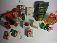 Overview of 15 vintage Avon bottles, boxes, and novelty packaging with colorful patterns and various shapes