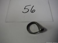 Top view of the handmade small horseshoe nail ring showing the loop and nail head.