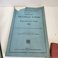 Blue softcover Fifth Annual Report of the Ontario Agricultural College and Experimental Farm 1909 with torn top cover corner