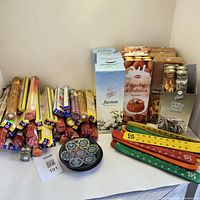 Full lot showing multiple boxed incense sticks and cones stacked, with wood and soapstone incense holders displayed in front.