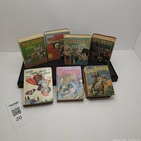 Seven vintage children's pocket books arranged in two rows on a flat surface.