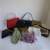 Overview photo showing all eight vintage purses of various styles and materials arranged together.