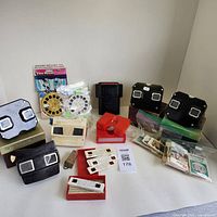 Wide view showing entire collection including multiple View-Master viewers, slide reels, collectible cards, and guide books.