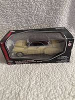 Photo of boxed 1/24 scale Motormax metal die-cast replica model car of a Chevy Bel Air in yellow with a black roof.
