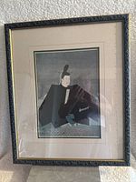 Front view of the wood framed artwork print showing a seated Japanese Minamoto figure in traditional attire on muted tones background with double layered matting.