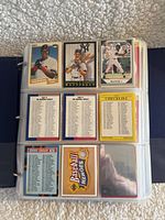 Photo showing three baseball cards at top and six checklist/back cards at bottom on one binder page, displaying players from early 1990s MLB.