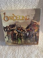 Front view of boxed Bardsung: Fables expansion game showing title and fantasy character artwork.