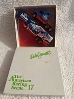 Box containing diecast car and truck tractor inside original packaging