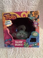 Front view of boxed DreamWorks Trolls Glow Buddies Talking Branch toy featuring LED lights and 5-hour timer.