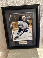 Front view of black wood picture frame showing Alexander Mogilny hockey photo, with matte and nameplate