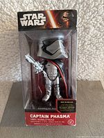 Front view of Captain Phasma Funko Wacky Wobbler bobblehead figure in original packaging, showing figure in silver armor with blaster rifle and red cape inside clear box along with Star Wars branding.