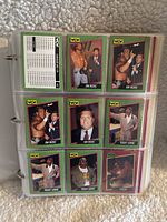 Front and back views of WCW wrestling trading cards featuring Jim Ross and Teddy Long characters in a binder's plastic sleeves.