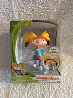 Front view of Arnold bobblehead in original packaging showing the figure and branding