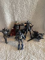 Five plastic action figures arranged together showing character details