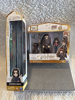 Front view of the packaged Severus Snape figure and Friendship Mini Harry Potter set showing window box packaging and visible contents.