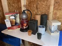 Multiple candles and candle warmers including boxed Black & Lamp candle warmer, Yankee Candle jar, various pillar and votive candles, glass candle warmers