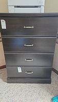 Front view of the chest showing four drawers with silver metal handles.