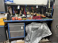 Front elevation view of work bench loaded with tools (tools not included).