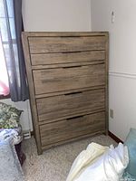 Front view of Havertys wooden chest of drawers with five drawers and rustic finish.