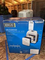 Box showing IDYLIS Air Purifier front with image and components inside the unit such as the HEPA filter, carbon pre-filter.