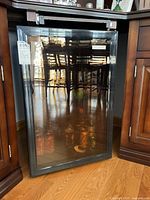 Front view of the Vissani wine refrigerator with glass door showing reflection of room interior.