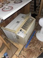 Side angled view of GE window air conditioner showing side vent and mounting brackets.