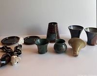 Close view of pottery items from a side angle showing shape and colors