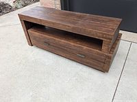 TV console showing two drawers with metal handles and open shelf above, rustic coffee finish.