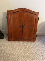 Closed wooden wall mount case with two doors and metal handles