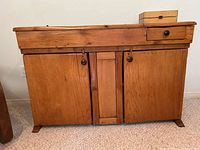Front view of antique pine dry sink showing drawer and two-door cabinet