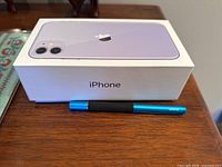 Boxed iPhone packaging with stylus laid in front on table