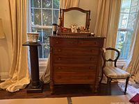 Front view of dresser with mirror and display items