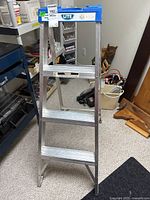 Front view of aluminum step ladder with blue top labeled 'Lite'