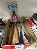 Full box showing two hammers, crow bar, and packaged snap ring pliers