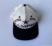 Front view of vintage 1994 Dallas Cowboys Super Bowl Champions hat with white front and black brim.