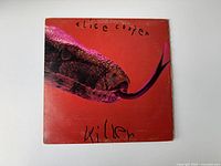 Front cover of vintage Alice Cooper 'Killers' vinyl album showing red background with a close-up of a snake head and handwritten style lettering.