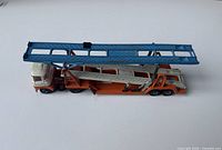Top side view of the vintage Corgi Major Transporter showing the white and red cab, orange transporter section, and blue extendable upper platform.