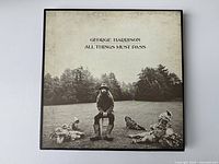 Front cover of vintage George Harrison album "All Things Must Pass" showing artwork and text