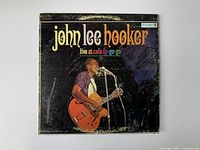 Front cover of vintage John Lee Hooker vinyl record showing artist playing guitar and album title.