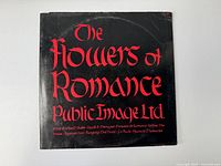 Back of vinyl record album sleeve with gothic red text listing album title and song names.