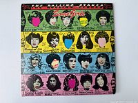 Front cover of the vinyl album Some Girls by The Rolling Stones with pop art and band member faces.