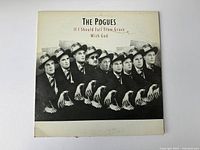 Front cover of The Pogues vinyl album showing men in black suits and hats